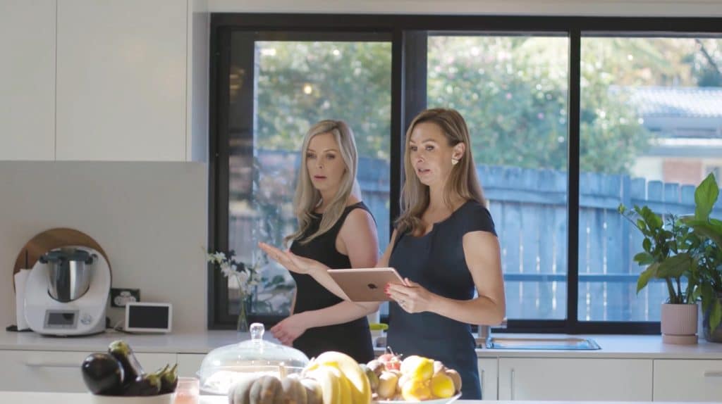 property manager consulting investor about managing rental property in modern kitchen