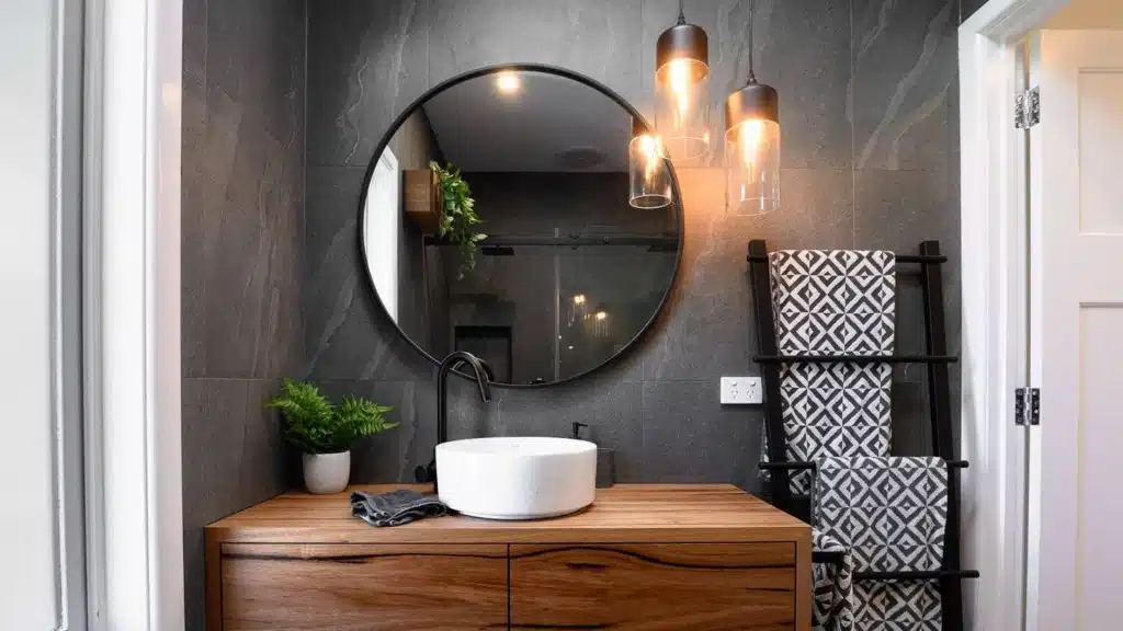 modern bathroom renovation with timber vanity and round mirror showcasing profitable renovation design
