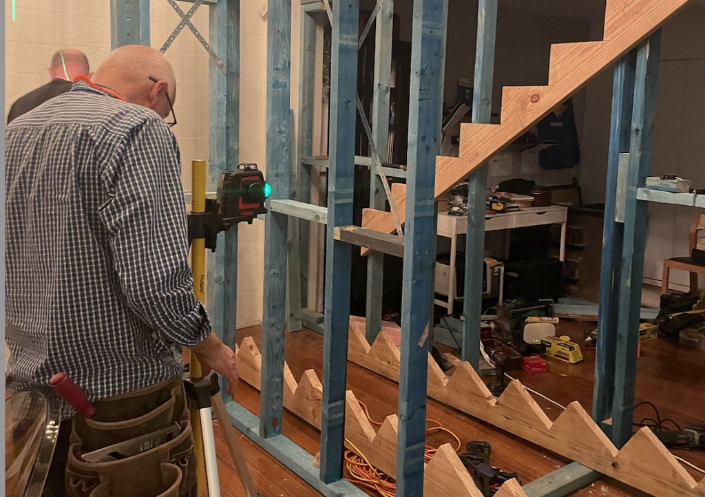 tradesperson managing renovation staircase installation