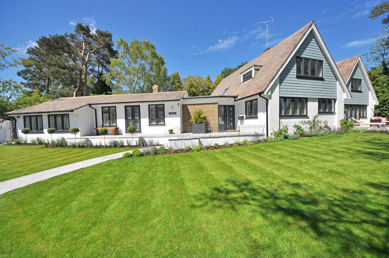 Renovated modern house exterior with lush lawn – property flipping example