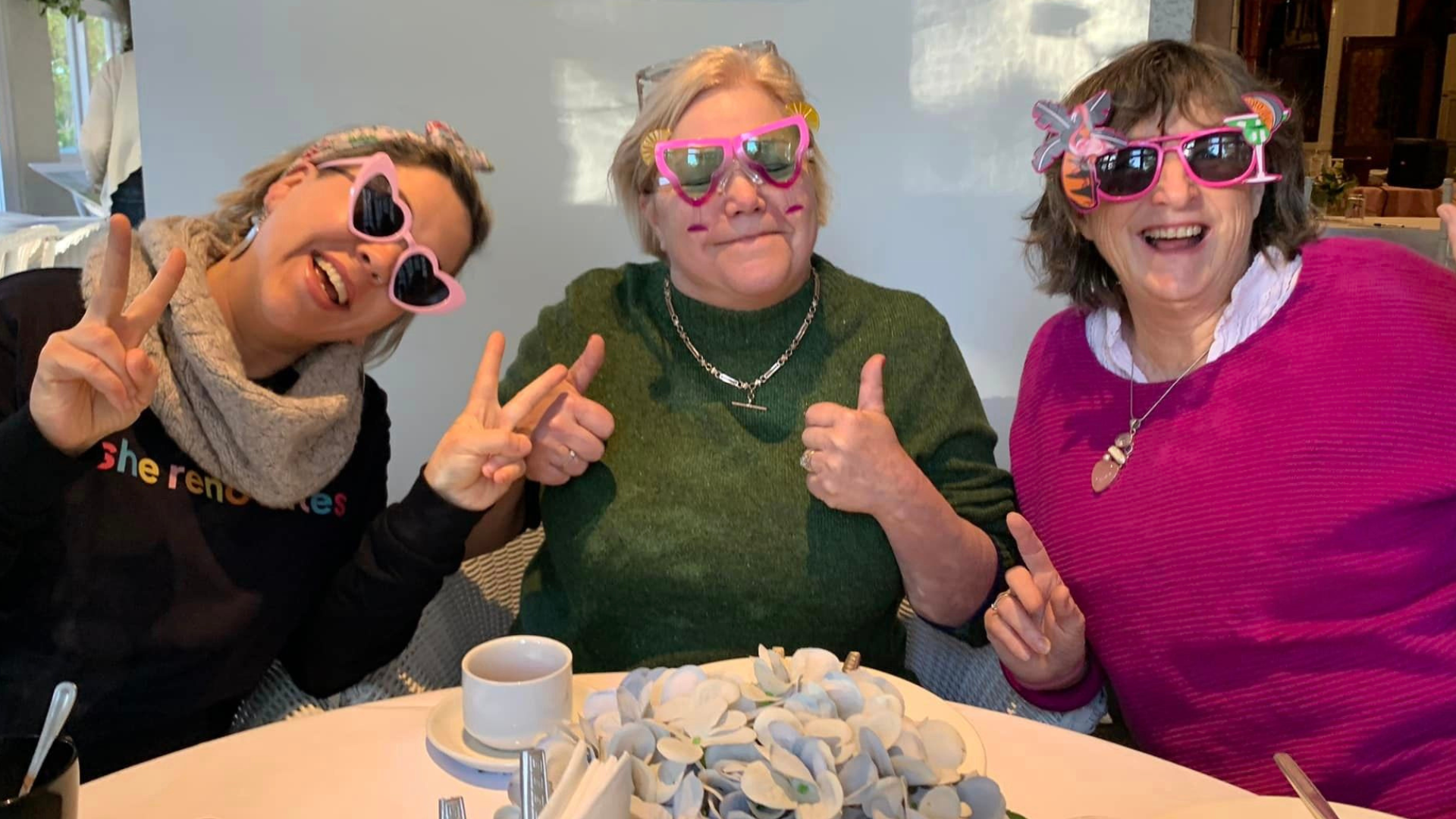 Women over 50 embracing positive age mindset and confidence at a renovation community event