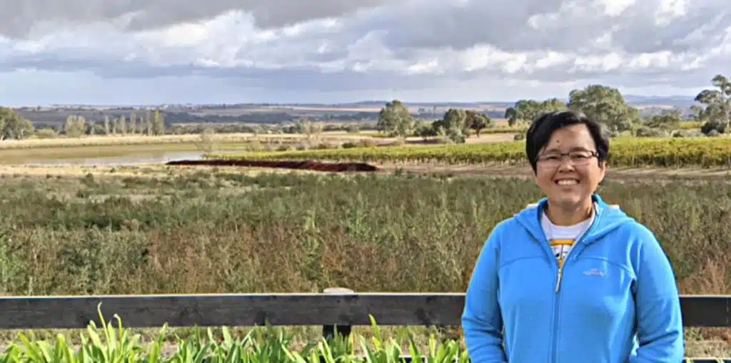 Foong Koh Buckland standing in Adelaide countryside, successful pharmacist turned renovator for profit.