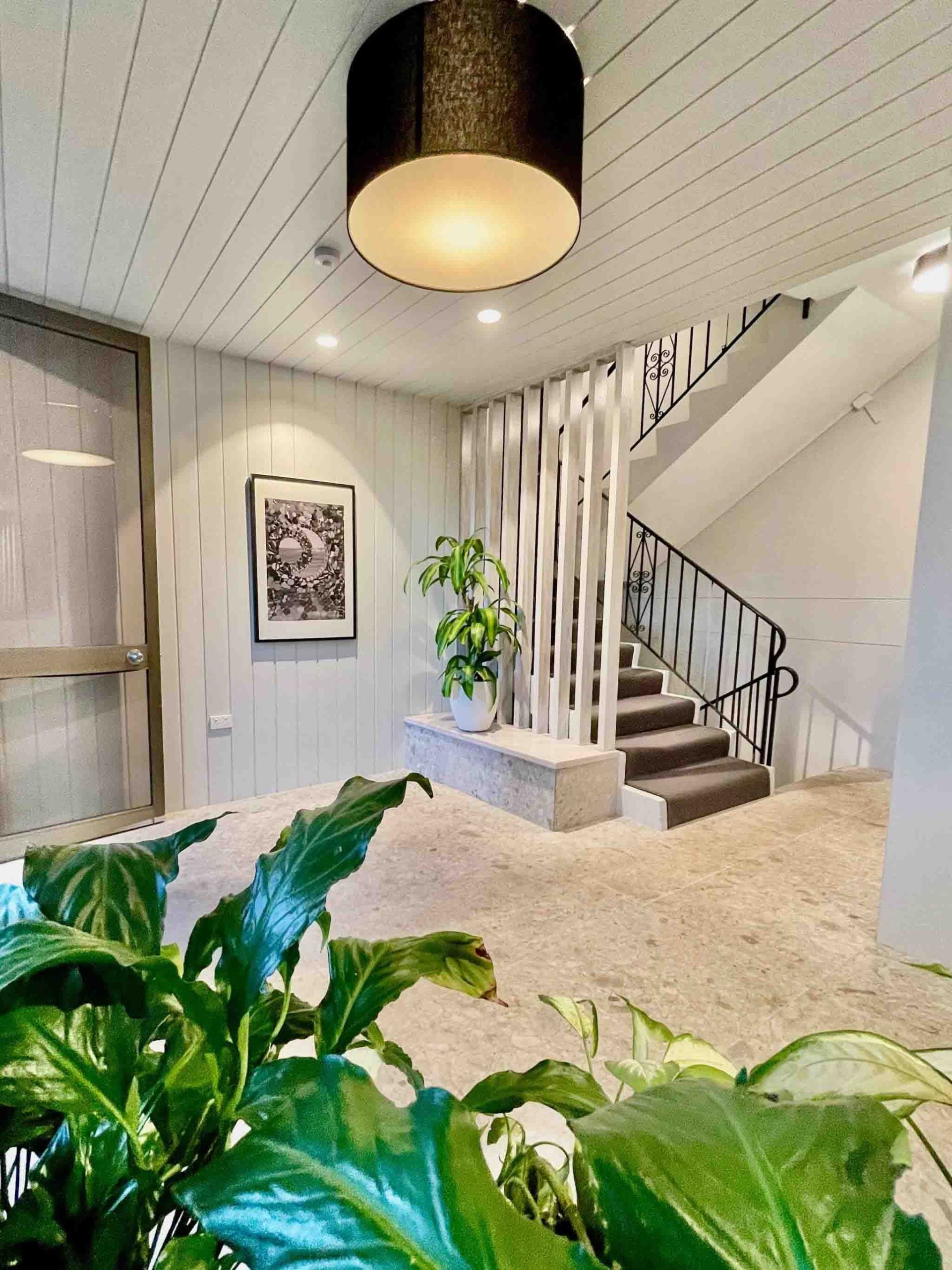 After photo showing renovated Bondi strata lobby with new lighting and plants