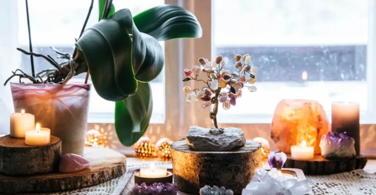 Candles and crystals on table showcasing Feng Shui home decor for positive energy