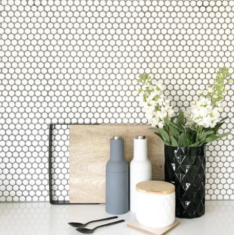 Penny tile splashback in kitchen with home styling accessories
