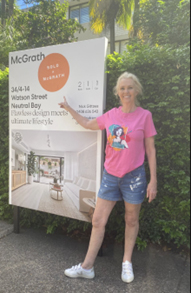 Home renovator celebrating successful house flip with sold sign – property flipping success story