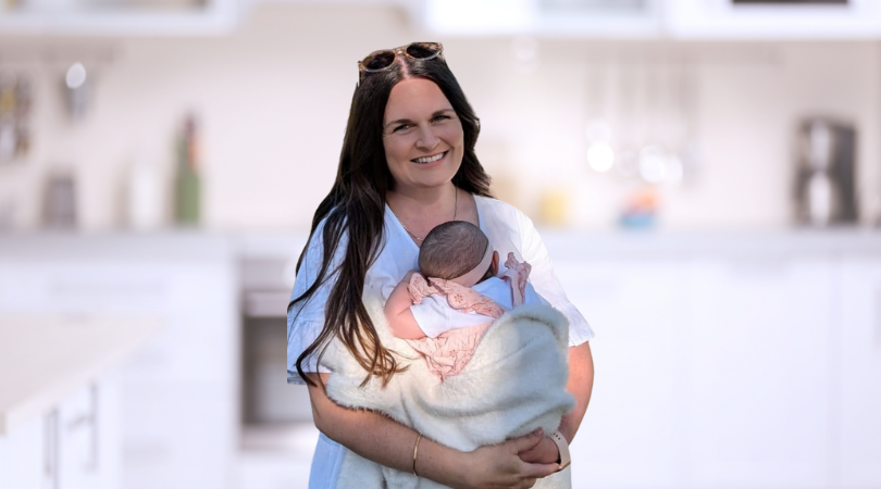 Maddy from The School of Renovating holding her baby after becoming mortgage free at 32